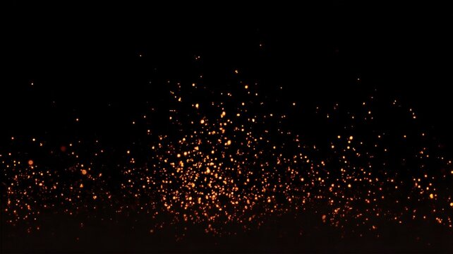 Glowing fiery orange sparks and embers rising from fire floating on isolated pure black background for overlays design