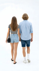 Fototapeta premium Couple's Stroll: A couple strolls hand in hand, seen from the back, dressed in casual attire, embarking on a shared journey and exploring their surroundings.