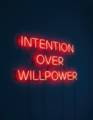 Obraz premium Red neon sign glowing on a dark wall with the message 