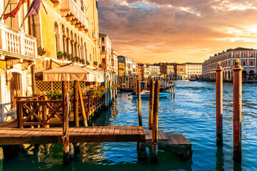romantic view of a canal in Venice with boats and blue water and beautiful vintage buildings around the cityscape © Yaroslav