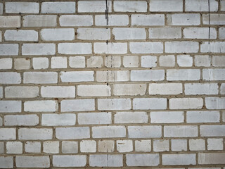 Fototapeta premium Urban wall with brick texture showing signs of use and wear in a city setting