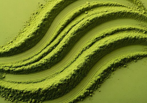 Vibrant green matcha tea powder spread in elegant wavy lines on a matching green background