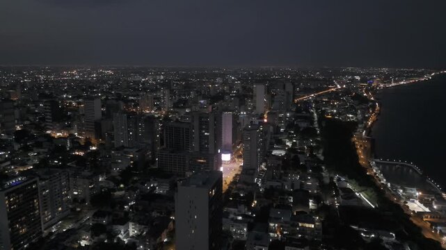 Drone flies north toward Avenida Julius Nyerere at night in Maputo, Mozambique