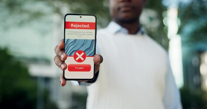 Hands, person or phone screen with reject message in city, online banking or loan application decline. Denied alert, credit request or man with digital financial services, try again option or mobile