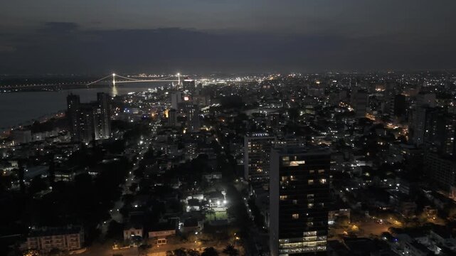 Drone lowers over Jardim dos Namorados with view of Polana Cimento A at night in Maputo, Mozambique