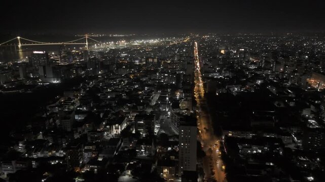 Drone flies west along Avenida 24 de Julho at night in Maputo, Mozambique
