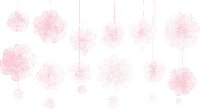 Delicate pink paper pom poms hanging against a bright white background with soft focus