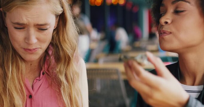 Women, friends and eating seafood at restaurant with oyster meal, taste testing and unique flavor. Smile, people or dining with shellfish for luxury delicacy, gourmet experience and cuisine appetizer