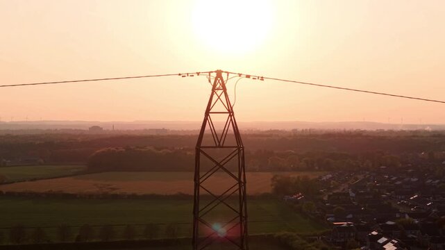 Aerial view of Armthorpe featuring residential houses and green fields under a hazy golden sunset in Doncaster, England, United Kingdom.