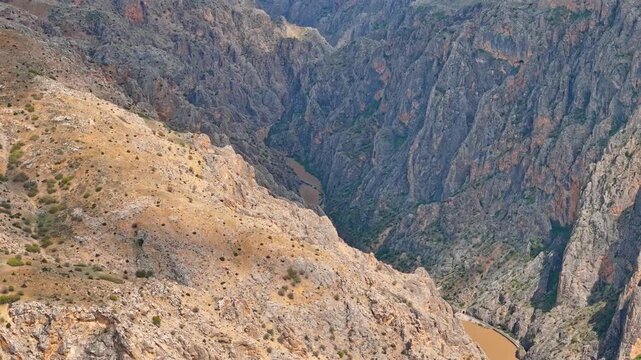 Spectacular deep canyon landscape with a river flowing between steep rocky cliffs