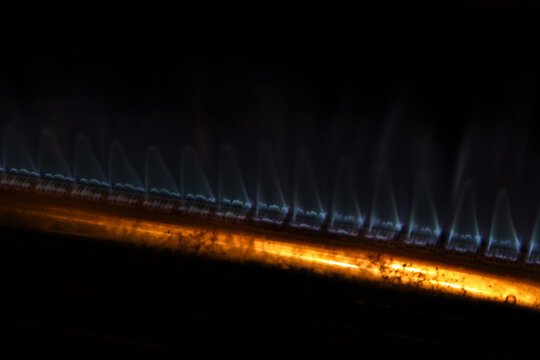 acro abstract shot of a glowing heating element or fiber optic texture with a warm orange light gradient.