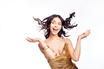Naklejka premium Joyful young woman in a gold sequin dress celebrating with windblown hair — glamorous party fashion portrait showing confidence, fun and festive energy