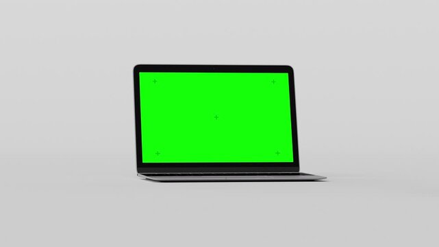 Seamless loop of rotating smartphone, laptop, tablet, and smartwatch. Green screens with tracking markers for easy content replacement on a neutral grey background. 3D digital device mockup