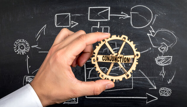 Hand holding a gear with the word Conjunction in the middle of a chalkboard diagram.
