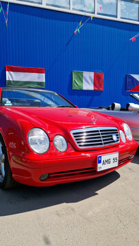 Kyiv, Ukraine - May 3, 2026: Red Mercedes-Benz CLK convertible (W208 body) at a car exhibition. Open-top car parked next to other cars. Open-air exhibition of retro and modern cars