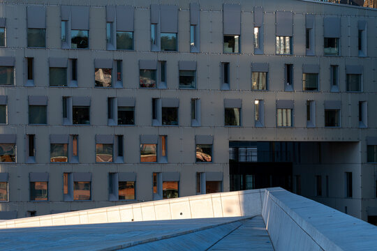 Repeating window grid makes an office facade as modern minimal architecture building and urban perspective create clean foreground space for design