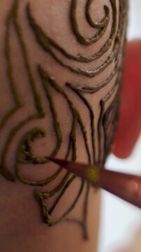 Close-up of a bald Caucasian man with henna tattoo on scalp, abstract dark brown ornaments