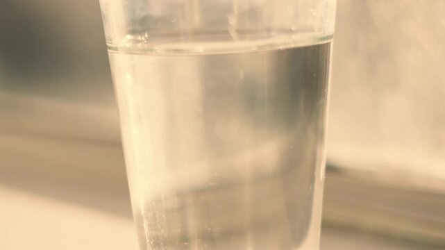 Clear Glass of Water in Warm Natural Light. H20. Refreshing Drink. 4K.