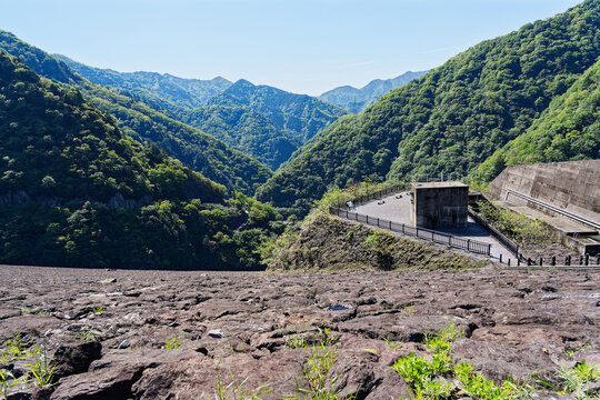 Fresh Green Mountain Valley with Rocky Foreground and Observation Area in Spring