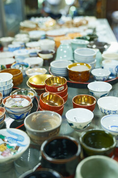Assorted Ceramic Bowls and Cups Displayed for Sale at a Local Craft Shop