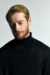 Obraz premium Stylish young man exuding confidence in a trendy black turtleneck sweater