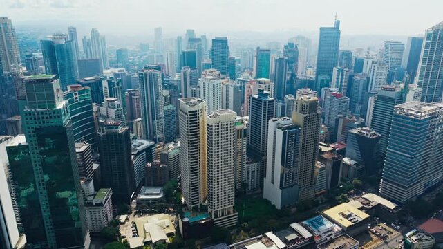 Establishing, drone descends over Makati City Metro Manila Philippines skyline