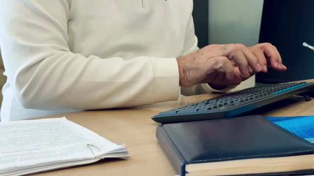 Business routine: document check and data entry on computer, no face, 4K UHD