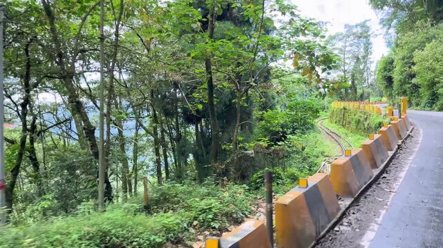 A narrow-gauge Toy Train line runs alongside the road.