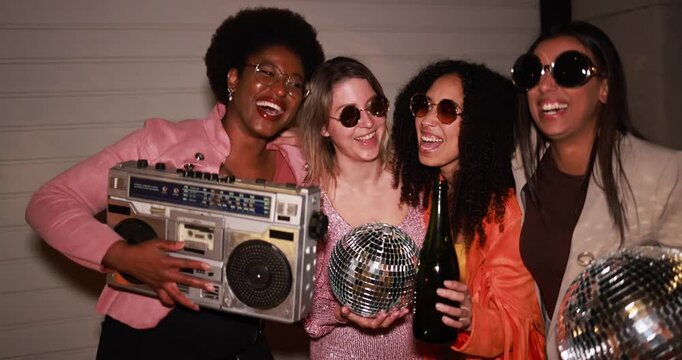 Happy multiracial girls dancing, drinking champagne and listening music outdoor - Party, summer and street nightlife concept 