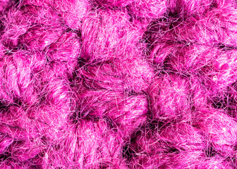Obraz premium Knitted woolen fabric pattern in rich magenta
