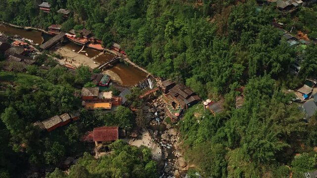 Cat Cat Village, Sapa, Vietnam - Traditional Houses are Nestled Along the River, Surrounded by Lush Greenery and Natural Beauty - Orbit Drone Shot