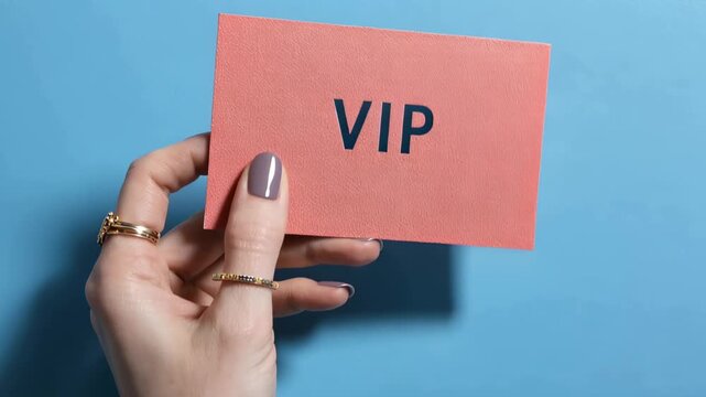 Holding a VIP card with a solid blue background during a special event or gathering