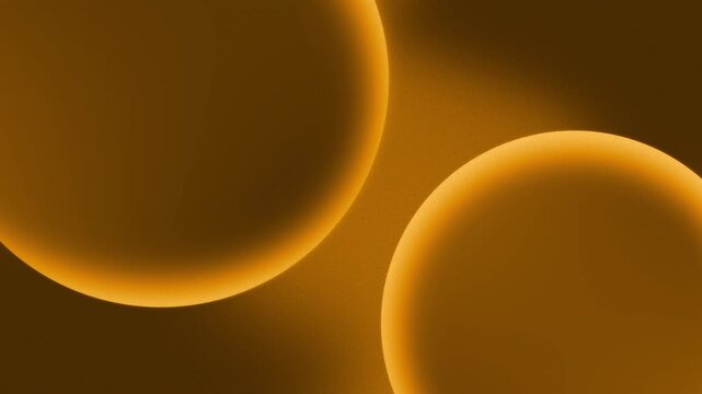 Two gold color abstract planets drift diagonally towards each other, and finally slowly overlapping in warm amber light, creating a calm hypnotic animation of depth, glow, and calm cosmic motion
