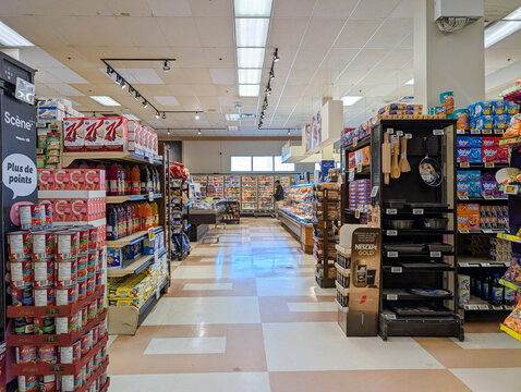 Quebec, Canada, 25 April 2026 : A supermarket interior features aisles stocked with Kellogg's cereals, Aylmer canned goods, and other food items.