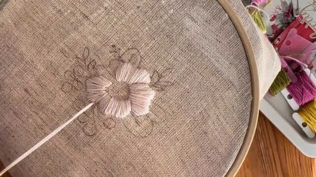 Macro close up of embroidery stitches on fabric, textile detail, pink thread
