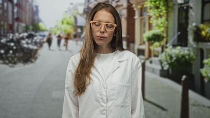 Obraz premium Woman scientist hispanic young in white lab coat standing on city street, pensive head tilt and closed eyes while reflecting; contemplation.