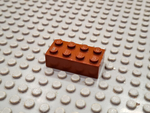ingle Brown Plastic Lego Brick Placed on a Gray Baseplate as Illustrative Editorial for Creative Building and Educational Construction Hobby on December 19, 2025 in Bangkok, Thailand 