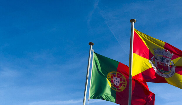 Wavy Spain and Potugal Flags and Clear Blue Sky