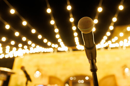 Professional microphone on a stand with festive bokeh lights