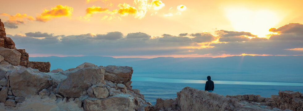 Beautiful sunrise over the Dead Sea. View from Masada fortress. Ruins of King Herod's palace in Judaean Desert
