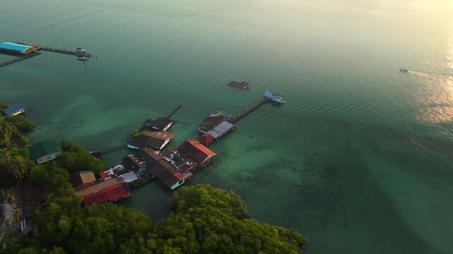 Aerial landscape of a traditional coastal fishing village with stilt houses and aquaculture