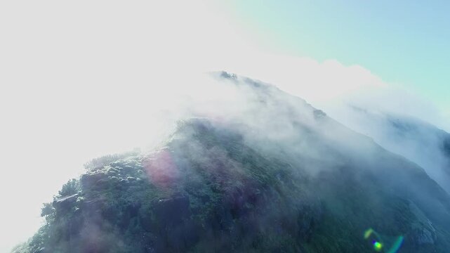 High angle view of mountain range covered in dense fog creating misty scenic landscape