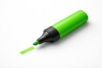 Fototapeta premium Bright green highlighter isolated on a plain white texture with copy space