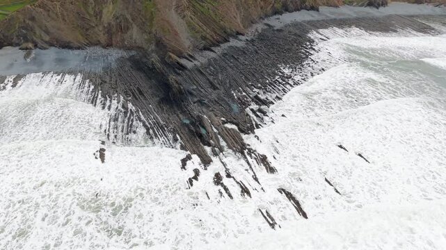 Aerial view of surroundings at Spekes Mill Mouth waterfall which is  located in a beautiful coast area of rugged valleys, high cliffs and wildflowers flourish. Drone POV of United Kingdom landscapes. 