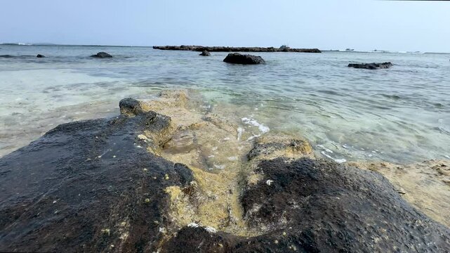 Sunlight Through Natural Sea Arch on Rocky Shore at Low Tide, Ly Son Island, Vietnam