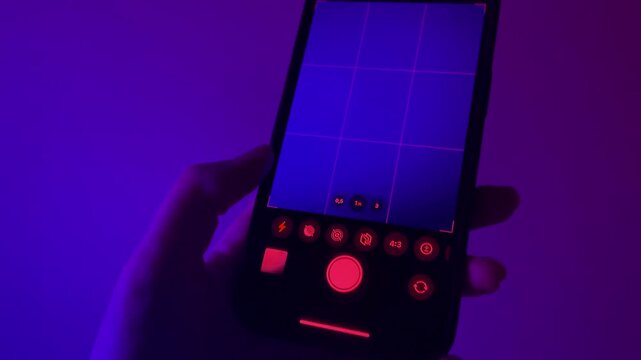 hand holding phone and taking photo with flash