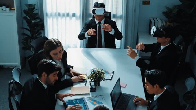 Top view of manager working on laptop and sending data analysis to business people by using VR glass headset while diverse team planning marketing strategy and looking at financial graph. Directorate.