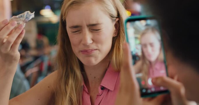 Influencer, friends and picture in restaurant with seafood, content creation or taste test for blog. Happy, women and photography in diner with eating oyster, review cuisine or phone for social media