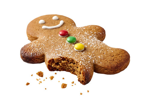 A delicious gingerbread man with colorful candy buttons and powdered sugar on a white surface being eaten.