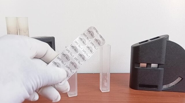 Water Testing Equipment Showing A Chlorine Comparator Kit With DPD No 1 Tablets Card For Residual Chlorine Analysis